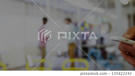 Holding white smartphone in right hand near coworkers discussing whiteboard in office, copy space 135822242