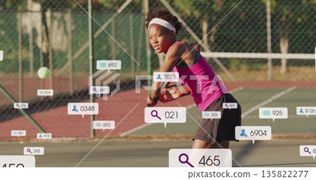 Swinging female tennis player holding racket, returning ball on outdoor court, wearing pink top Swinging female tennis player holding racket, returning ball on outdoor court, wearing pink top 135822277