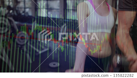 Woman wearing sportswear lifting barbell in gym area, with weight rack, bikes and chart overlay 135822282