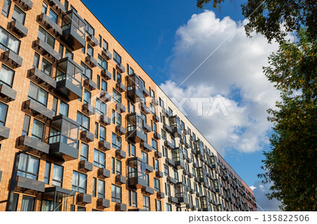 Modern residential building with many windows, air conditioner boxes. Urban architecture and real estate development. new multi-story residential building. Climate control system Modern residential building with many windows, air conditioner boxes. Urban architecture and real estate development. new multi-story residential building. Climate control system 135822506