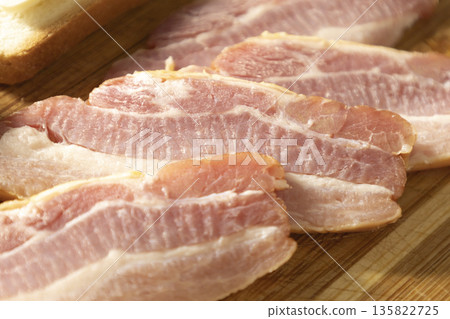 Dried smoked chicken breast cut into pieces for sandwiches.Smoked bacon with layers of meat. The pieces of pork brisket for breakfast or lunch. 135822725