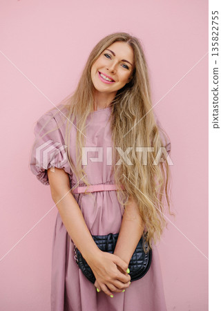 Charming Woman In Pink Dress Smiling Outdoors 135822755