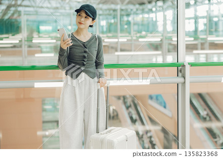 A woman leaving the airport for a trip (Photo courtesy of Kansai International Airport (KIX)) A woman leaving the airport for a trip (Photo courtesy of Kansai International Airport (KIX)) 135823368