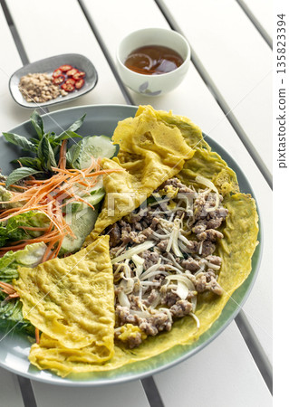 Banh xeo vietnamese traditional food pancake crepe with pork and salad in Vietnam Banh xeo vietnamese traditional food pancake crepe with pork and salad in Vietnam 135823394