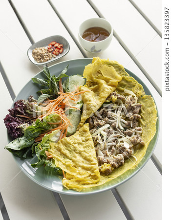 Banh xeo vietnamese traditional food pancake crepe with pork and salad in Vietnam Banh xeo vietnamese traditional food pancake crepe with pork and salad in Vietnam 135823397