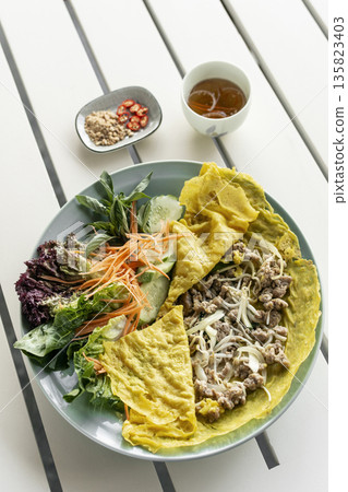 Banh xeo vietnamese traditional food pancake crepe with pork and salad in Vietnam Banh xeo vietnamese traditional food pancake crepe with pork and salad in Vietnam 135823403