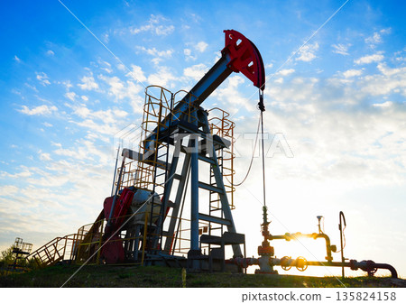 Pumpjack in oil well of oil field on sunrise in Industrial crude area. Crude pump jack on oil field 135824158