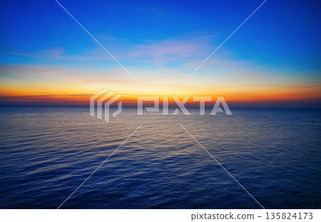 Sunset sea at evening night. Sunset over ocean with blue sky orange horizon at evening time. Sunset sea at evening night. Sunset over ocean with blue sky orange horizon at evening time. 135824173
