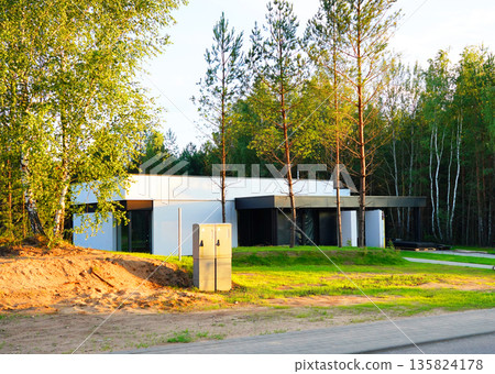 Construction of Modern House Surrounded Trees. Building modern Double Court house in forest.  135824178