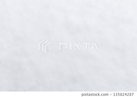 Snow covers trees and the ground in a natural area. The scene shows a bright sky with clouds and a cold winter atmosphere. Trees appear laden with snow Snow covers trees and the ground in a natural area. The scene shows a bright sky with clouds and a cold winter atmosphere. Trees appear laden with snow 135824287