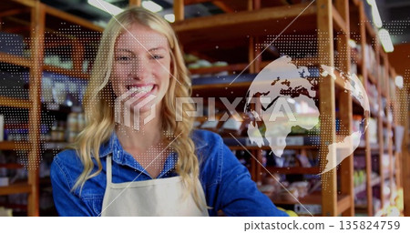 Smiling adult woman wearing apron arranging bread on shelves inside bakery with world map overlay 135824759