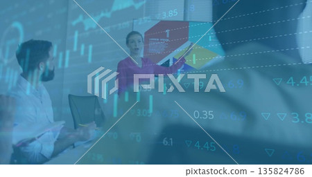 Pointing presenter in magenta blouse highlighting stock chart in conference room with notebook pen Pointing presenter in magenta blouse highlighting stock chart in conference room with notebook pen 135824786