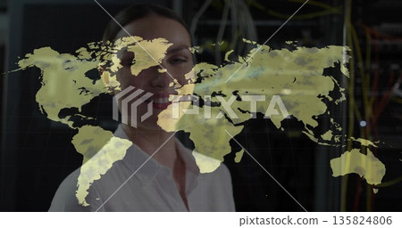 IT engineer wearing white shirt analyzing projected world map in server room, with racks and cables IT engineer wearing white shirt analyzing projected world map in server room, with racks and cables 135824806