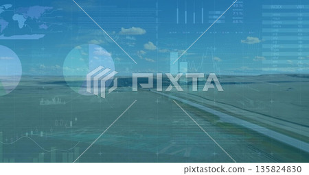 Displaying straight paved canal bisecting rural plain under blue sky, with digital chart overlays Displaying straight paved canal bisecting rural plain under blue sky, with digital chart overlays 135824830