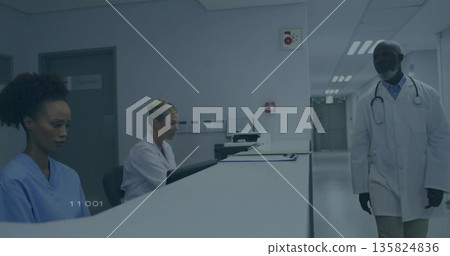 Walking doctor in white coat with stethoscope passing curved nurses station at hospital, copy space 135824836