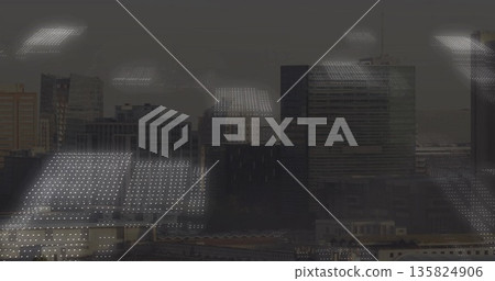 Framing high-rise office window reflecting ceiling lights grid over layered skyline, glass facades 135824906