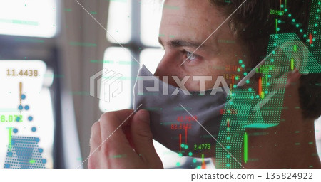 Adjusting gray mask, analyst monitoring candlestick charts with data overlay in office, copy space 135824922