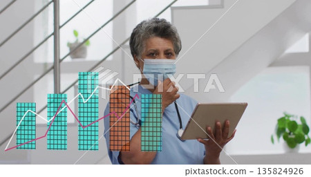Reviewing nurse in blue scrubs tapping tablet in clinic hallway, with stethoscope and chart overlay Reviewing nurse in blue scrubs tapping tablet in clinic hallway, with stethoscope and chart overlay 135824926