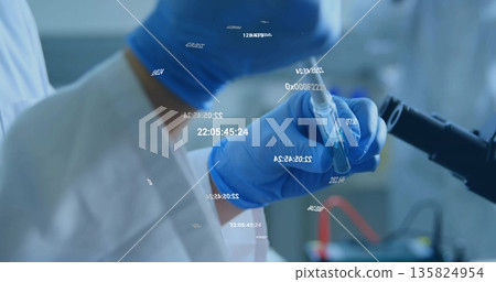 Presenting gloved hand in lab coat holding test tube near microscope in lab, with digital overlays Presenting gloved hand in lab coat holding test tube near microscope in lab, with digital overlays 135824954