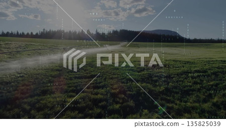 Spraying center pivot irrigation system watering crops on rural farmland, with fine water mist Spraying center pivot irrigation system watering crops on rural farmland, with fine water mist 135825039