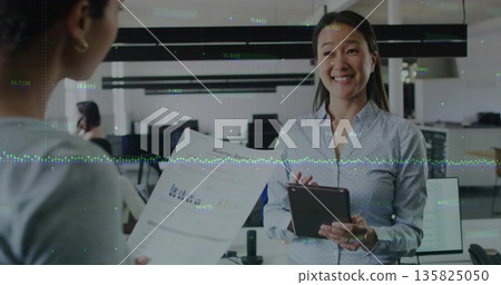 Reviewing Korean woman in blue shirt holding tablet and printed report in office, copy space Reviewing Korean woman in blue shirt holding tablet and printed report in office, copy space 135825050