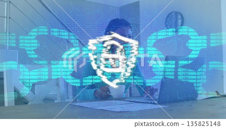 Manipulating IT specialist wearing tie interacting with digital interface at desk, with laptop 135825148