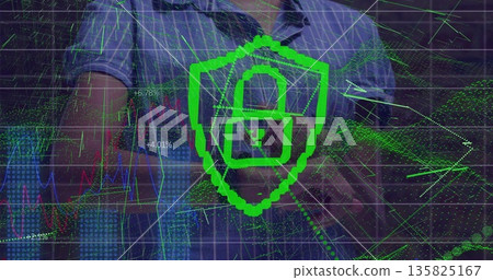 Typing IT professional in blue shirt analyzing security data on laptop at desk, with shield icon 135825167