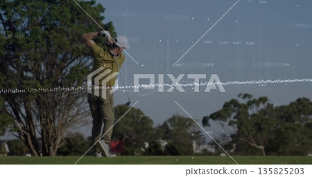 Swinging mature golfer finishing swing on fairway, with golf club, golf glove and data overlay 135825203