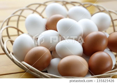 Raw eggs in a basket Raw eggs in a basket 135825426