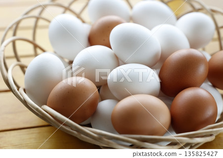 Raw eggs in a basket Raw eggs in a basket 135825427