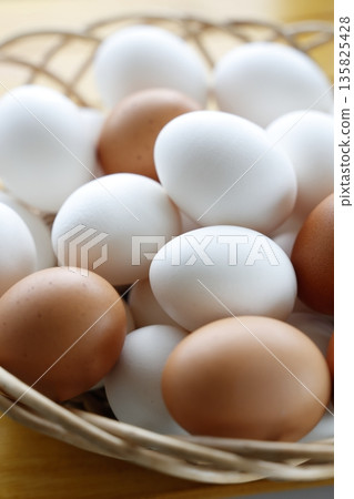 Raw eggs in a basket Raw eggs in a basket 135825428