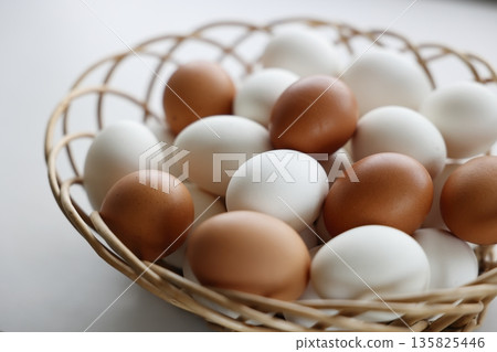Raw eggs in a basket Raw eggs in a basket 135825446