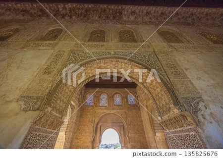 Ornate Islamic architecture and arches inside Alhambra, Granada Ornate Islamic architecture and arches inside Alhambra, Granada 135825676