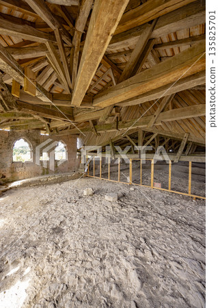 Old wooden roof beams inside historical building La Romieu Old wooden roof beams inside historical building La Romieu 135825701