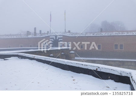 Terezin Little Fortress gate in winter fog Terezin Little Fortress gate in winter fog 135825718
