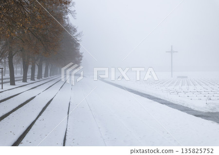 Terezin memorial in winter with cross and fog 135825752