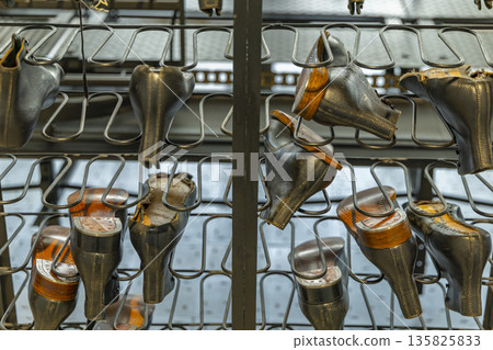 Shoes drying on manufacturing rack in Zlin factory 135825833