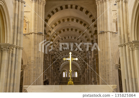Golden cross standing in historic Vezelay basilica nave Golden cross standing in historic Vezelay basilica nave 135825864