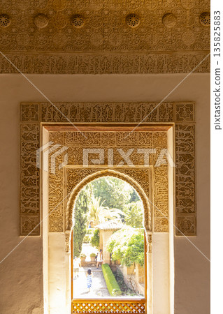 Ornate archway looking into Alhambra gardens in Granada, Spain Ornate archway looking into Alhambra gardens in Granada, Spain 135825883