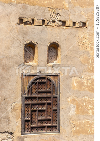 Alhambra wall with geometric wooden window in Granada 135825887