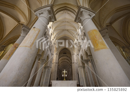 Vezelay Basilica interior with vaulted ceilings and glowing cross Vezelay Basilica interior with vaulted ceilings and glowing cross 135825892