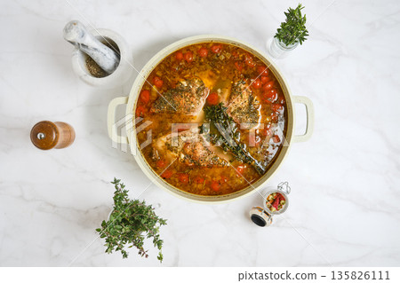 Rabbit stew with vegetables and herbs in a cooking pot on a marble surface Rabbit stew with vegetables and herbs in a cooking pot on a marble surface 135826111