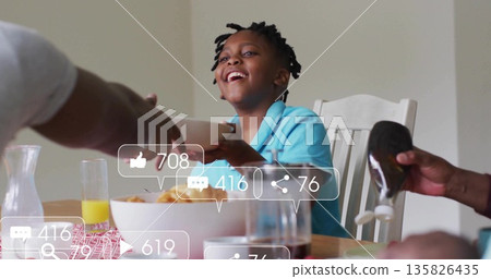 Smiling child wearing turquoise polo reaching for bowl at family dining table, with squeeze bottle Smiling child wearing turquoise polo reaching for bowl at family dining table, with squeeze bottle 135826435