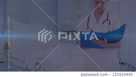 Nurse with stethoscope in scrubs writing with pen on blue clipboard at hospital bedside, copy space 135826445