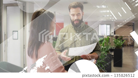 Reviewing office professionals analyzing printed document in open-plan office, with data overlays 135826512