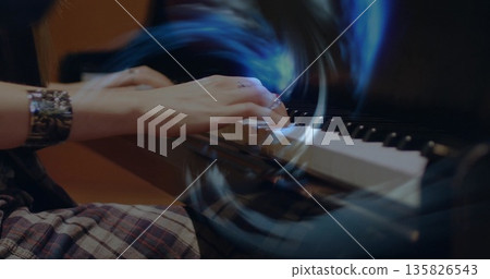 Playing pianist's hands moving over piano keyboard at music studio, with metallic cuff, plaid skirt Playing pianist's hands moving over piano keyboard at music studio, with metallic cuff, plaid skirt 135826543