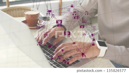 Typing man wearing beige top at cafe table, with silver laptop and floating purple network icons Typing man wearing beige top at cafe table, with silver laptop and floating purple network icons 135826577