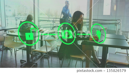 Typing woman wearing jacket on laptop in cafe with green padlock camera lightbulb icons, copy space Typing woman wearing jacket on laptop in cafe with green padlock camera lightbulb icons, copy space 135826579