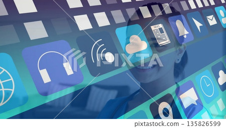 Smiling Indian woman in blazer showing app icons for headphones, wifi at office lounge, copy space Smiling Indian woman in blazer showing app icons for headphones, wifi at office lounge, copy space 135826599