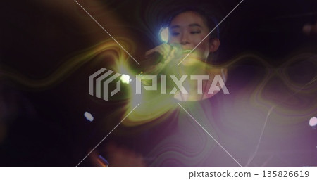 Singing Chinese singer in black long sleeve top on concert stage, with microphone, haze and lights Singing Chinese singer in black long sleeve top on concert stage, with microphone, haze and lights 135826619